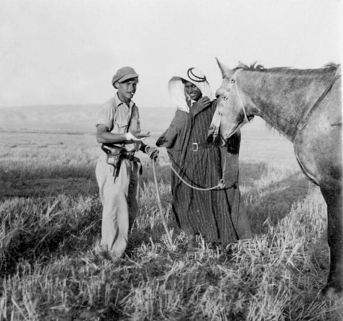 Guy with gun: Heheheh I got such a good deal - this fool knows NOTHING of negotiation Guy with hood: LOL. I just played dumb and got his horse in exchange for that cigarette he's smoking.