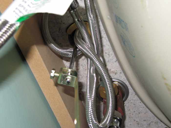 Underside of my bathroom vanity looking up at the bottom of the taps. This is a great reason to use a basin wrench when doing a job like this.