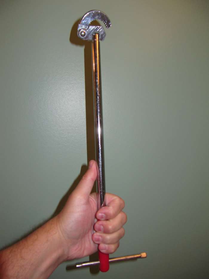 This is a Basin wrench used by plumbers to fit in tight spots to tighten and loosen hard to get to nuts in areas under sinks etc.