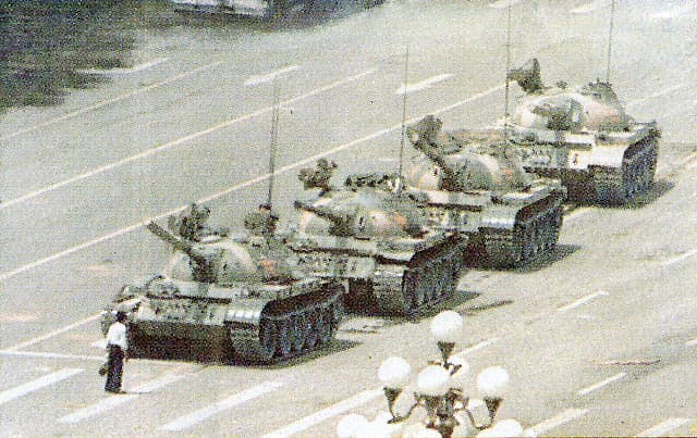 Tianamen,Beijing,China June 5,1989, An ordinary anonymous Chinese "The Unknown" stand defiant in front of a column of tanks sent to disperse Chinese students and workers protesting authoritarian rule