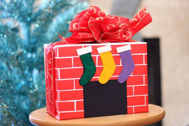 Tired of the same old holiday wrapping paper? Wrap you gift in a brick-pattern paper and make it look like a small fireplace.