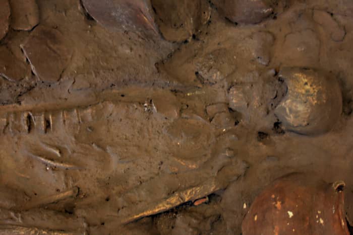 A skeleton found with a pottery vase (bottom right) at Ban Chiang (This is a plaster cast of the real skeleton but many other exhibits in the museum are authentic relics)