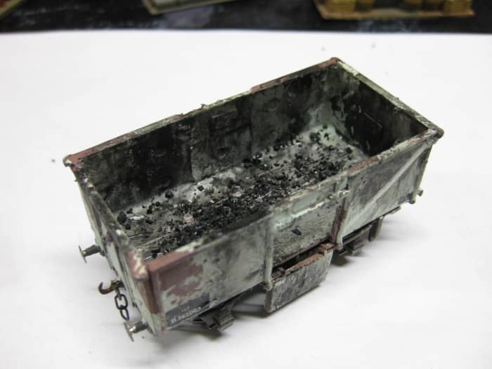 Another one of my own wagons. This is the Dapol 'Airfix' BR 16t mineral with one door down. Unswept coal 'residue' left in wagon bottom. Kit modified to take Smiths (W&H) 3 link coupling hook shaft and weighted on underside. Heavily weathered