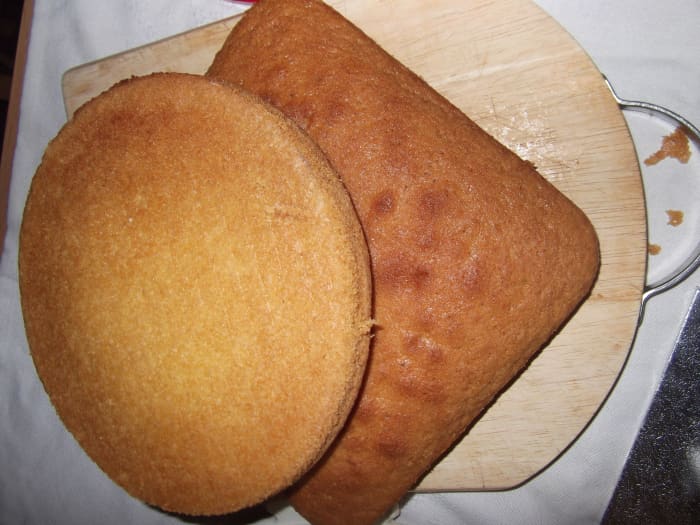 Put the square cake on an angle and place the round cake on top just under halfway on the square cake. Cut round the round cake.