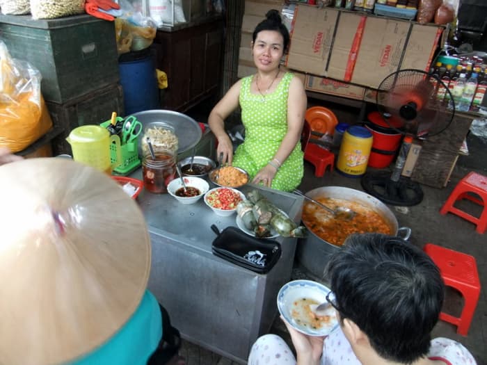 Street Photo in Hue, Vietnam: This woman sells Vietnamese porridge, at Dong Ba market in Hue