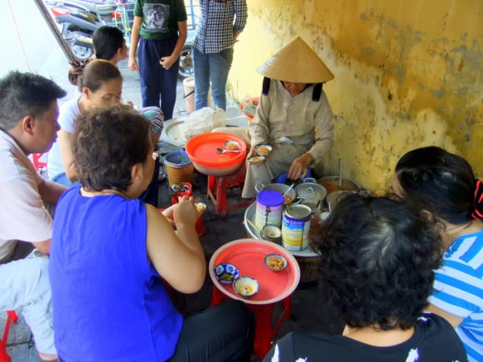 Street Photo in Hue, Vietnam: Enjoying the local fare from this street vendor in Hue, common street scenes here