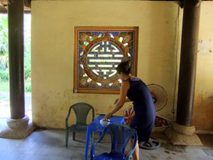 Street photography, to understand the people, their culture, and their lifestyle. Wife clearing table after family lunch.