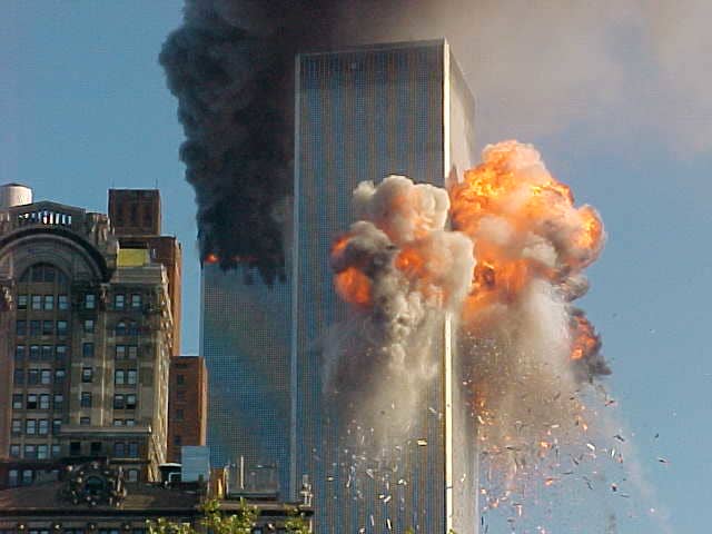 This photo is of the initial strike of WTC 2. WTC i has already been struck and is burning in the background. Later, both buildings collapsed in a cloud of dust and a swirl of controversy.