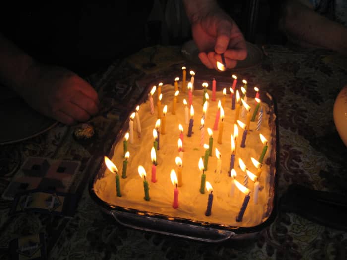 light candles starting from the inside and work to the outside to avoid stretching over the flames and risk getting burned.