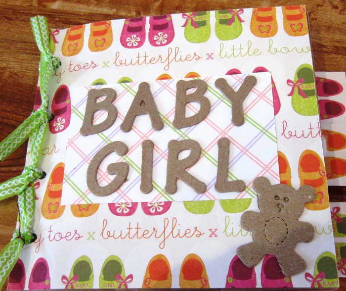 This paperbag scrapbook album is held together by ribbon tied through hole punches.