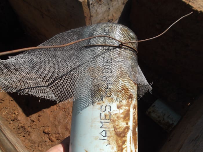 We held the metal screen in place with wire, then extended the screen and wire out into the mud while ramming that section.