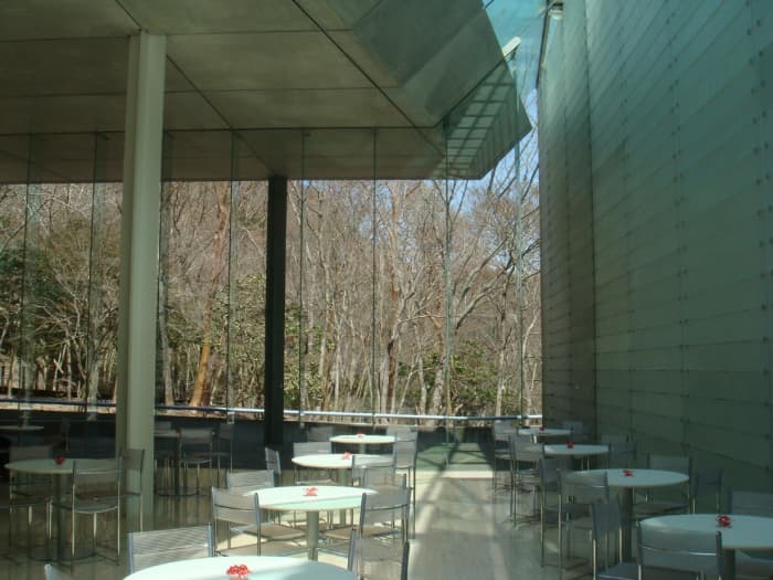 Cafe at Pola Museum. Can you appreciate the huge optic fiber covered wall, the glass wall to the forest and the natural light that seeps through.