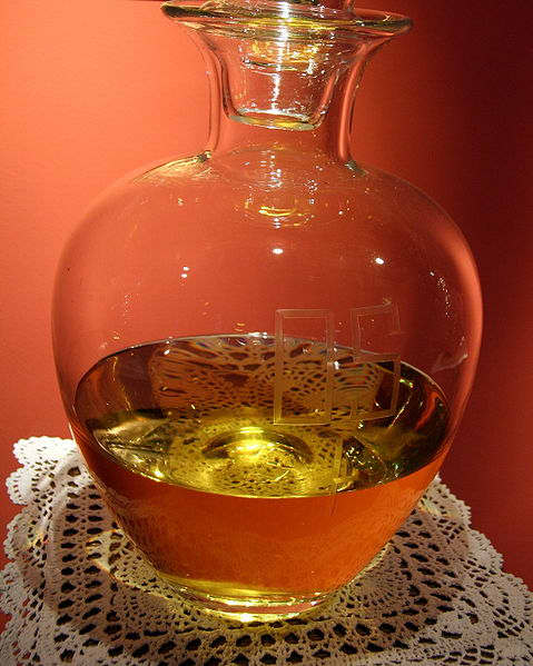 A jar of consecrated oil for ritual purposes. Etched into the glass are the letters "OS" for Oleum Sanctum, Latin for holy oil.
