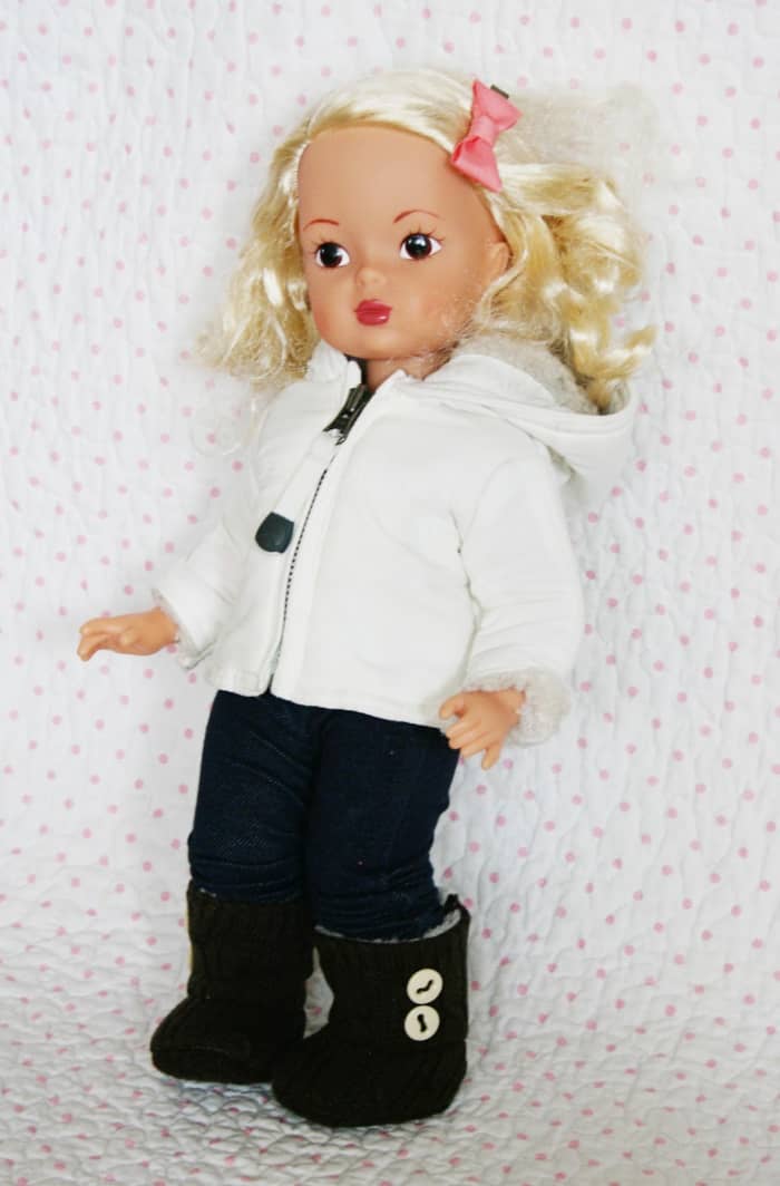 blonde doll with black pants white hoodie and tan UGGs