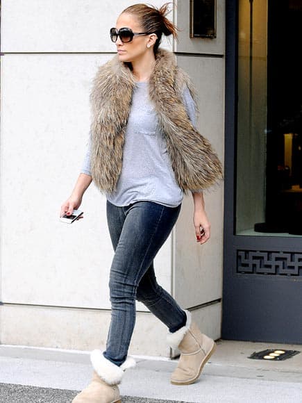 Stylish Jennifer Lopez gracefully pulls together the fur vest with blue jeans and a t shirt and Uggs
