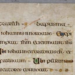 Page of text with illuminated letters at beginning of sentences and interlinear art.