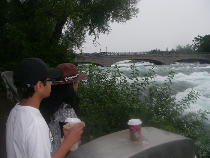 My children taking a rest during the hike. You can see the river turning into a rapid. Note that my daughter is pridefully wearing her Shenandoah National Park Rangers hat.