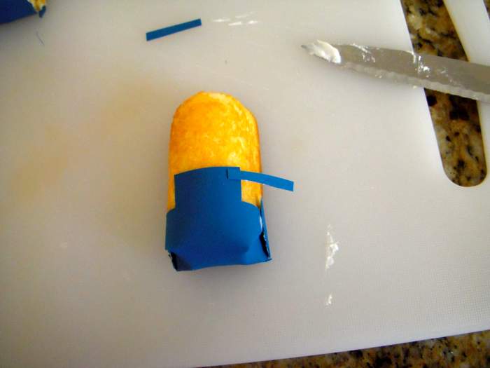 Carefully place suspenders around Twinkie, front to back. The suspenders should slightly overlap the bib.