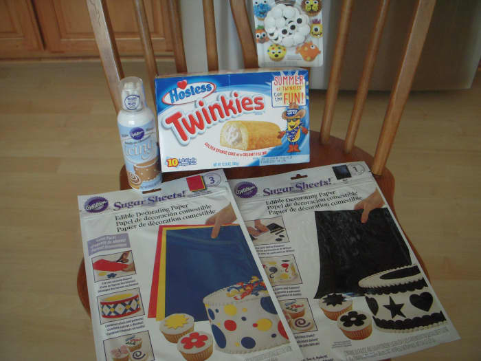 What you'll need: Hostess Twinkies, Wilton Sugar Sheets (blue and black,) icing in a can, Wilton sugar eyes (large size)