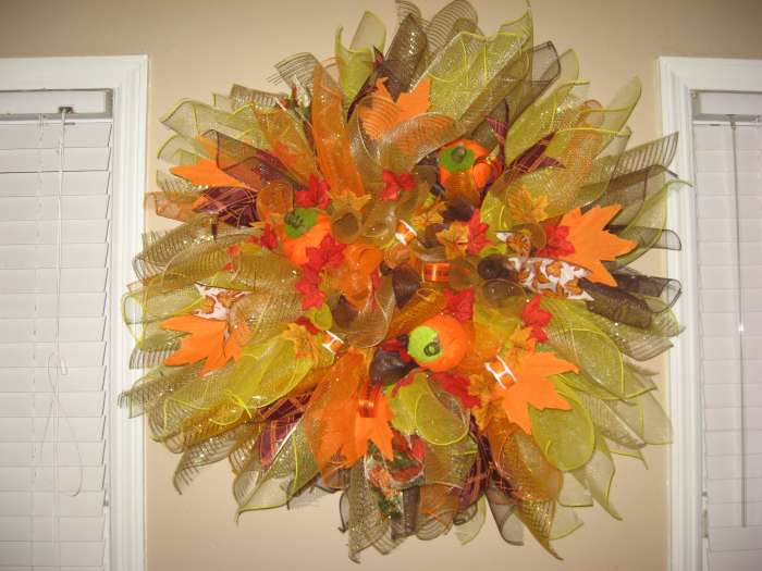 To this spiral fall wreath, I added ribbons, pumpkins, and autumn leaves.