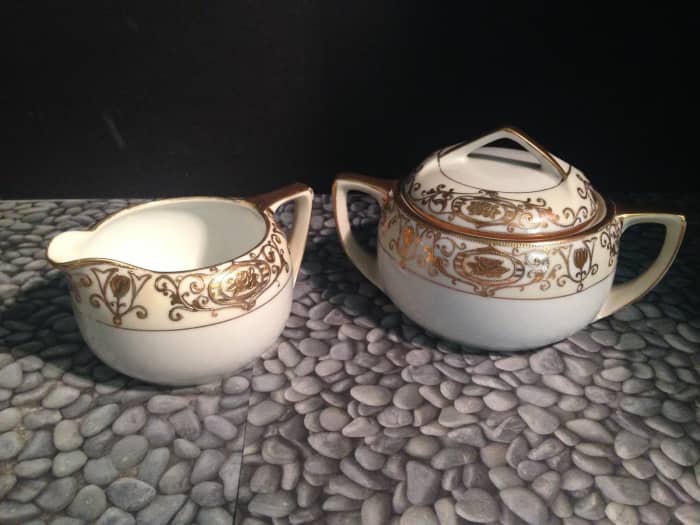 One set of cream and sugar made by the Nortake Company with the 24k gold hand painted Christmas Ball Pattern.