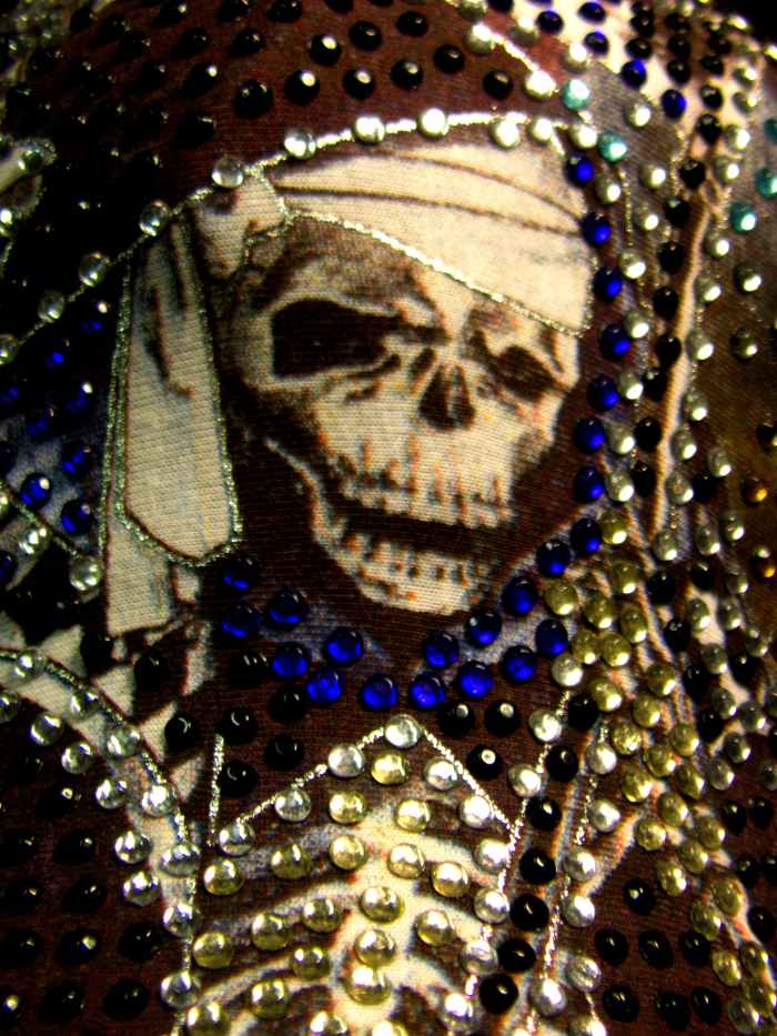 I love my Santa Muerte cap and wear it often. Isn't she pretty? You could certainly bling out a poster or even a print out to honor her.