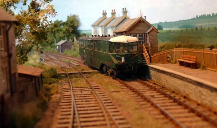 Model of an AEC GWR Railcar passing the signal box at this scale layout based on Radnor, Wales. An unusual design solution with streamlining and side fairing - for speed running?