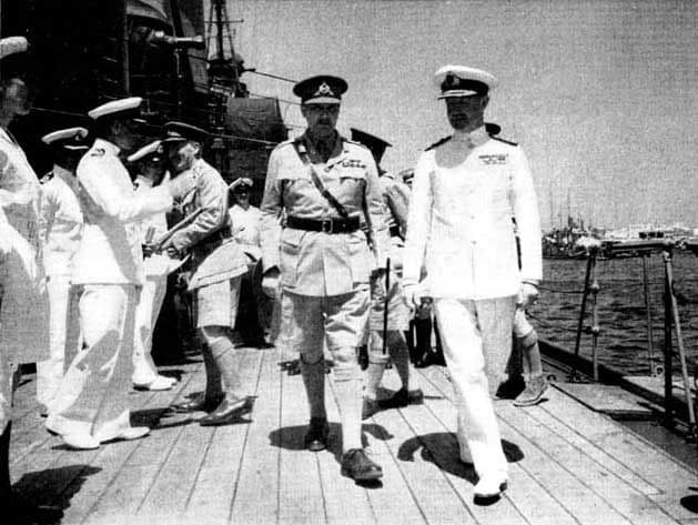 Admiral Cunningham (right) and Major General Freyberg walk the deck aboard HMS 'Phoebe' off Crete