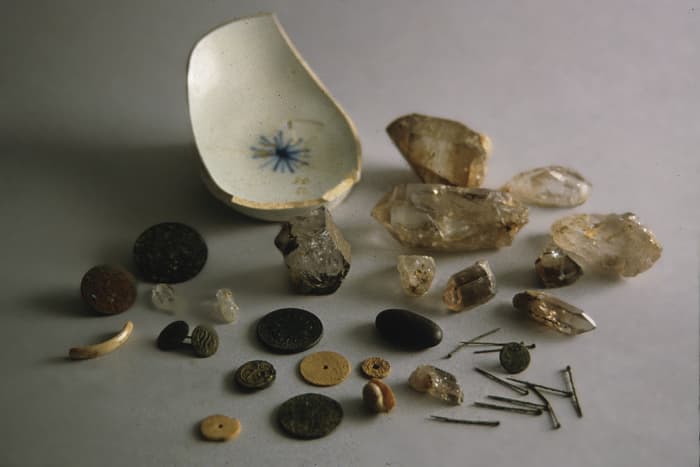 Pierced coins, buttons, straight pins, shells etc. Hoodoo items belonging to the slaves of Charles Carroll, signer of the Declaration of Independence.