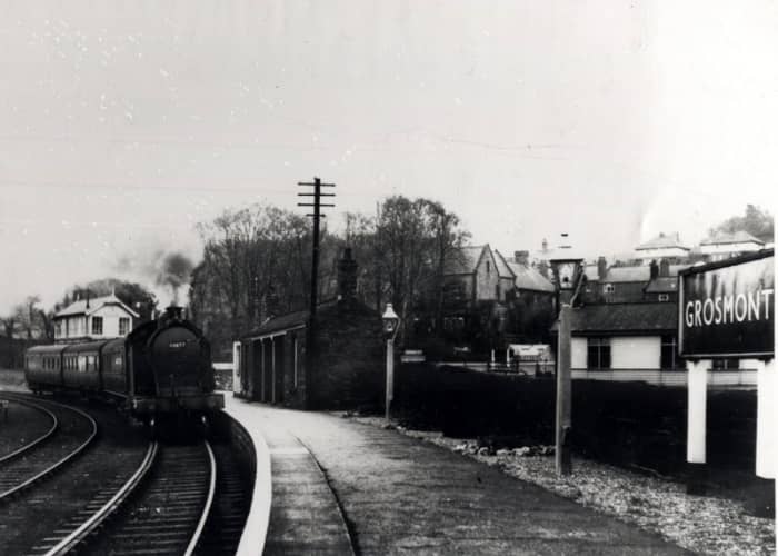 A Class A8 4-6-2 tank engine enters from Whitby. The platform shelter is still there, built by the NER in the mid-1860s. Trains to and from York came through the far platforms. Plinth-based signal cabin behind the engine was demolished mid-1980s