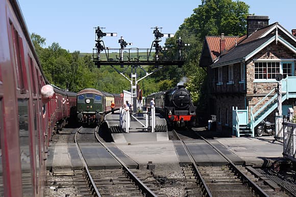 Grosmont station, North Yorkshire Moors Railway. The main platform on the left is used for non-stop onward travel to Whitby - NER Southern Div style signal cabin on the right (built 1995 with bricks retrieved from Whitby Town's 3-storey cabin