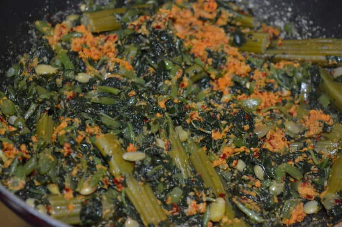 Step three: Mix the coconut mixture with cooked veggies. Add salt, tamarind pulp, and jaggery powder. Gently mix it.