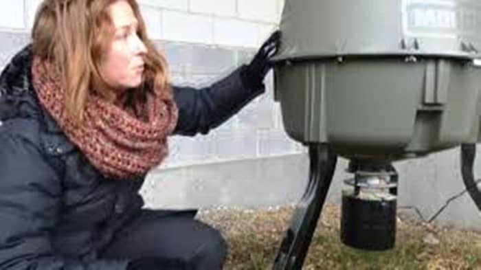 Sara Dubois, chief scientific officer with BC SPCA shows the feeding unit placed at the VCC-Clark SkyTrain station.