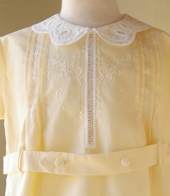 From Mrs. Bird: Butter Yellow Romper with Embroidery C.1950. Never worn, sunny, refreshing, yellow one-piece romper. Fancy white collar and cuffs with yellow-thread embroidery, looped cotton trim and fagoting.
