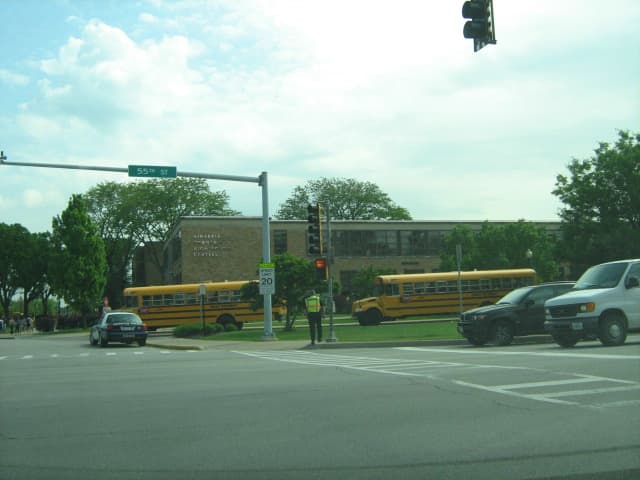 School buses and Hinsdale Police near crosswalk at 55th Street when Hinsdale Central High School dismisses