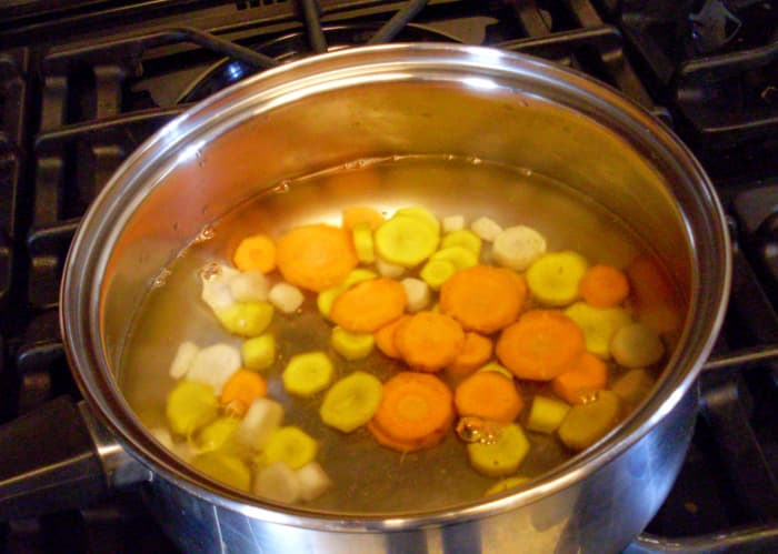 Put the carrot slices in boiling water for three minutes. This was the first batch, and all I had ready when the water boiled; you can put in more than this.