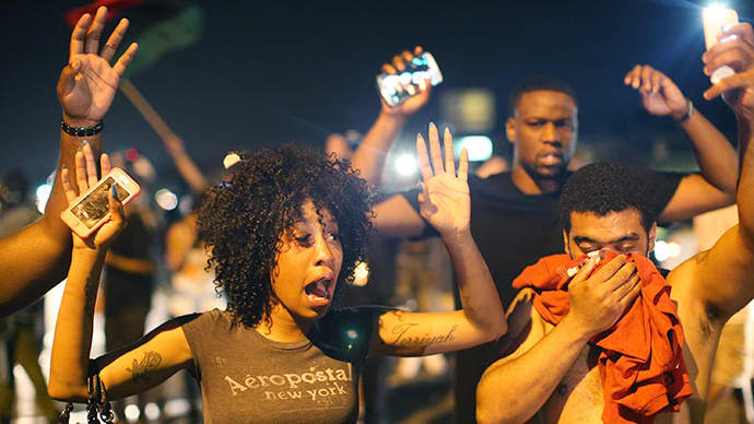 Demonstrators protesting the killing of teenager Michael Brown by a Ferguson police officer try to stand their ground despite being overcome by tear gas on August 17, 2014 in Ferguson, Missouri. (AFP Photo / Getty Images / Scott Olson)