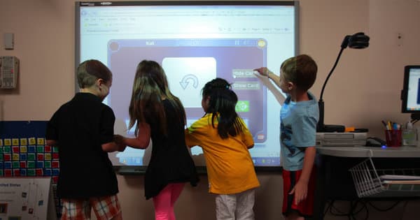 Students using an interactive whiteboard, part of an ambitious technology plan in the Kyrene School District in Arizona.