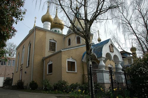 By entering the church together, the Greek Orthodox bride and groom make their marriage pledge - no vows are recited.