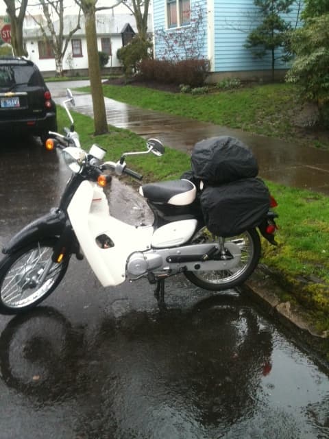 My SYM Symba just after I bought it on my first trip to work. Notice the saddle bags (with rain covers). Absolutely the perfect commuter.