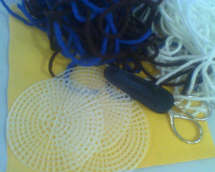 Yarn, sewing scissors, tapestry needles, and plastic canvas in various shapes are your basic supplies for this craft.