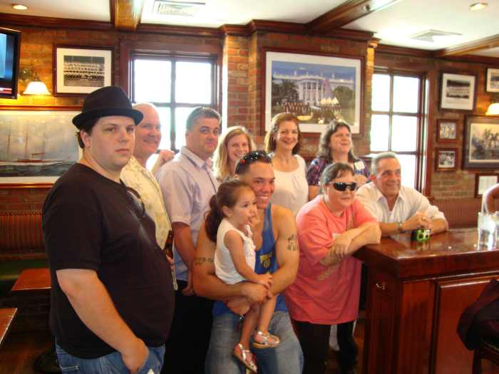 Family members get together. From left, top row, are Brandon Revels, Martin Torpey, Kieran Hogan, Natashah Revels Quinlan, Catherine Torpey, Beth Torpey Revels, and, first row, John Hogan IV (holding daughter, Valerie), Michelle Hogan, Michael Hogan