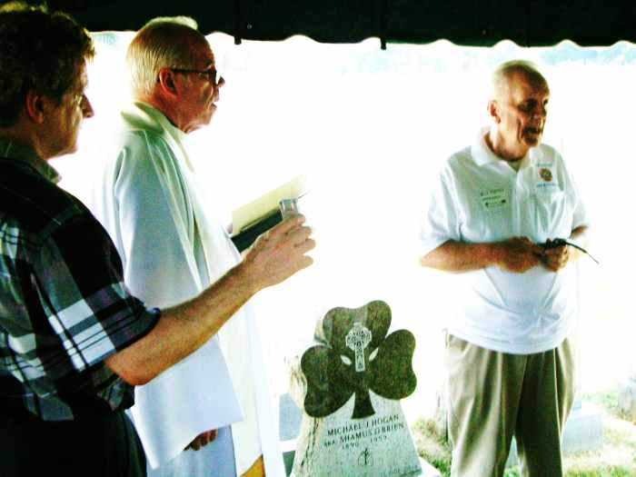 At the Blessing of the new Shamus O'Brien tombstone are Monsignor George Kuhn of St. Joseph Church and Shamus' grandson William F. Torpey. The tombstone features a shamrock and Celtic Cross as well as a pair of boxing gloves.