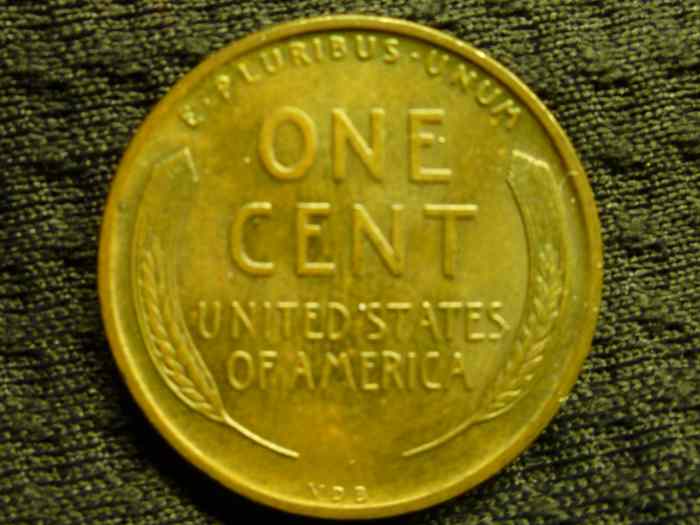Extremely Fine. Lettering and Design is bold, but there is wear along rim and mint luster has almost completely faded.
