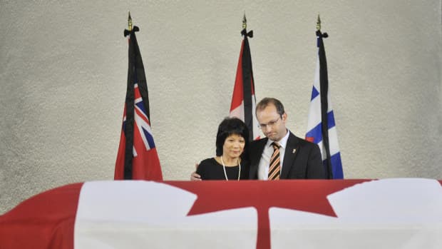 Olivia Chow and Mike Layton stand at the casket of NDP leader Jack Layton, placed to rest in Toronto City Hall in Toronto on Thursday, August 25, 2011.