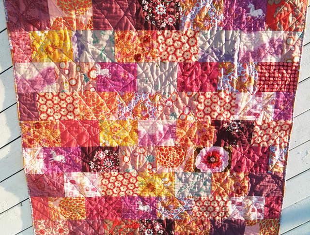 This modern quilt uses modern fabric with bold graphics and colors.