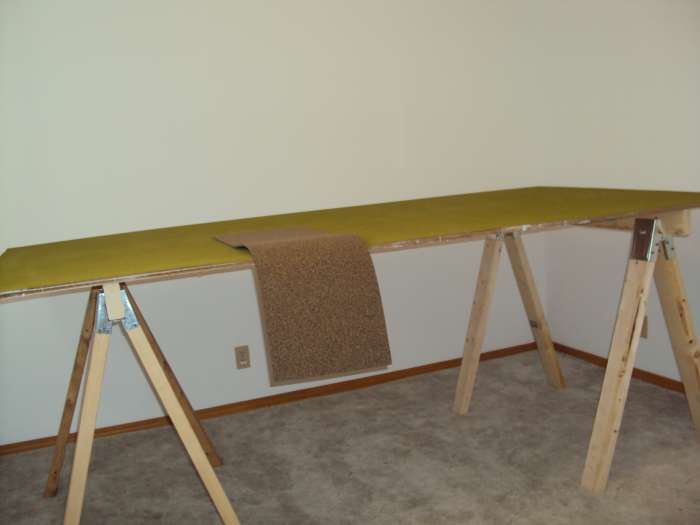 The cork board shown on top of the mat of grass will be cut in pieces and used to heighten structures to the level of the tracks.