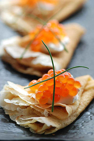 A popular Russian dish - blinis (crapes) with red caviar