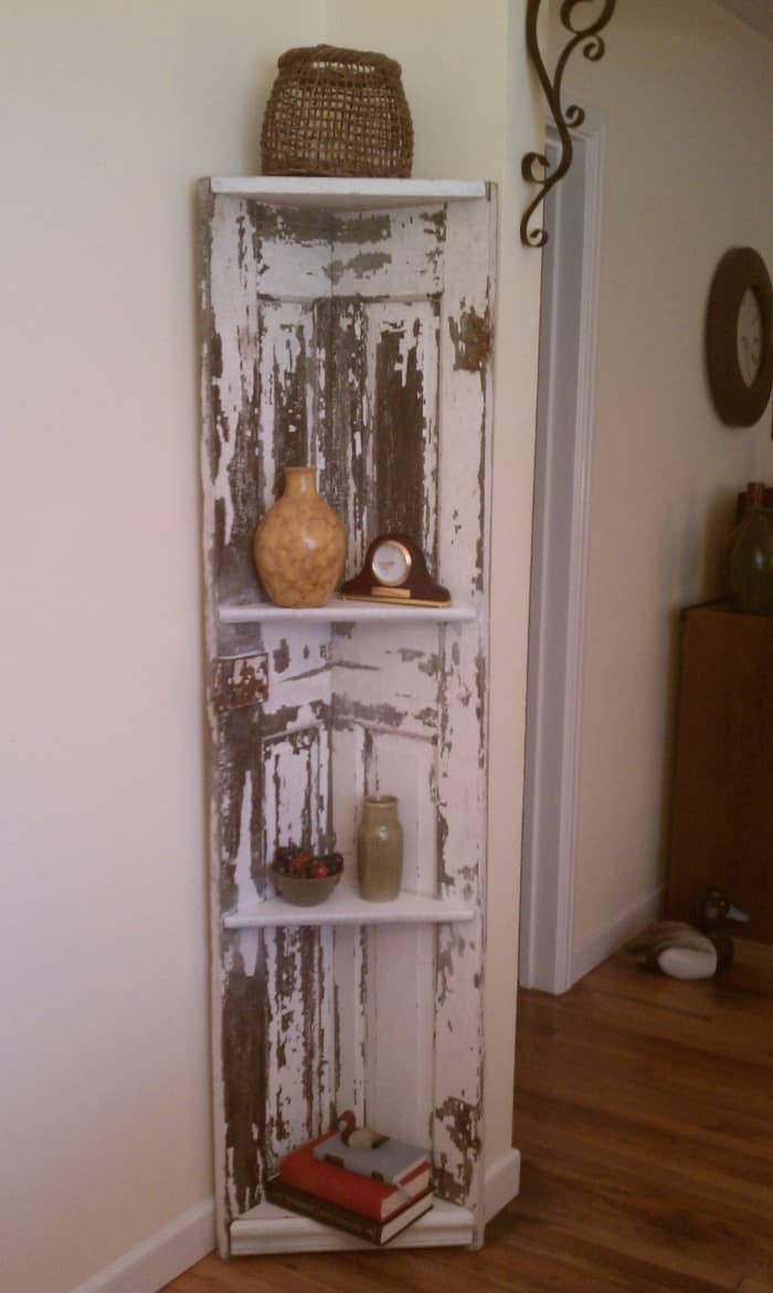 We created this great corner shelf out of an old door the paint was already beginning to flake so we helped it along with our sander leaving it heavily distressed and ready for the buyer to take home. Out total cost on this piece was less that $50.