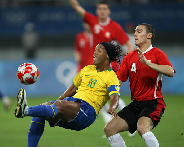 Brazil's Ronaldinho (10) and Belgium's Thomas Vermaelen in action during the teams' bronze medal match on Aug, 22. 2008. Brazil defeated Belgium twice, including a 3-0 result to win the bronze medal.
